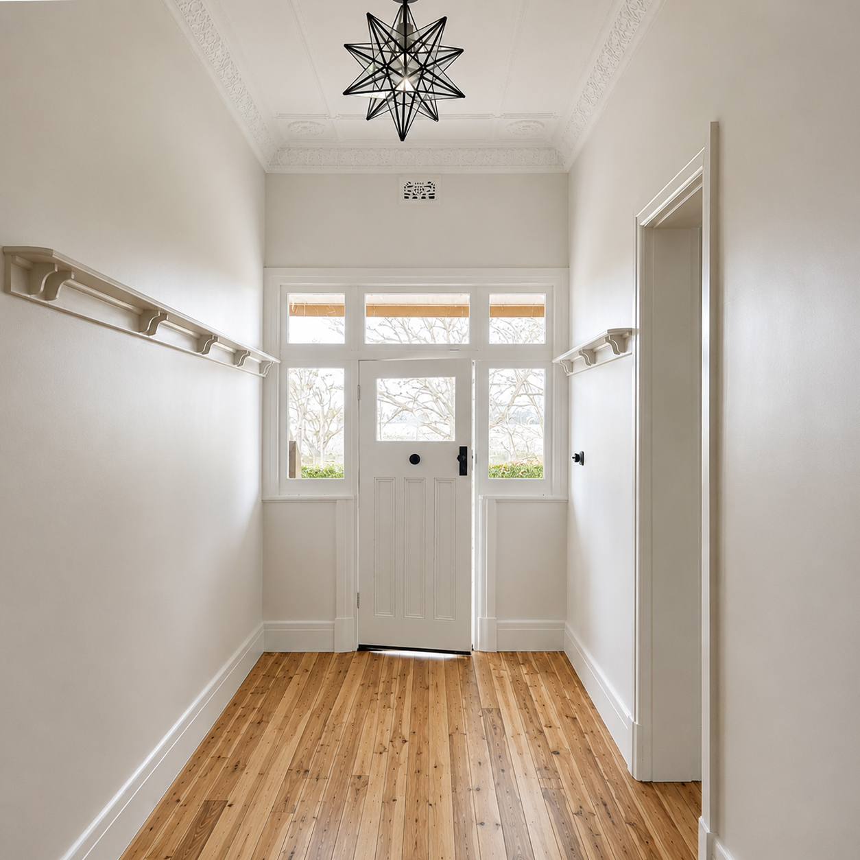 Heritage entry hallway with polished timber floors and ornate ceilings at Roachdale renovation by Travis Jones Building