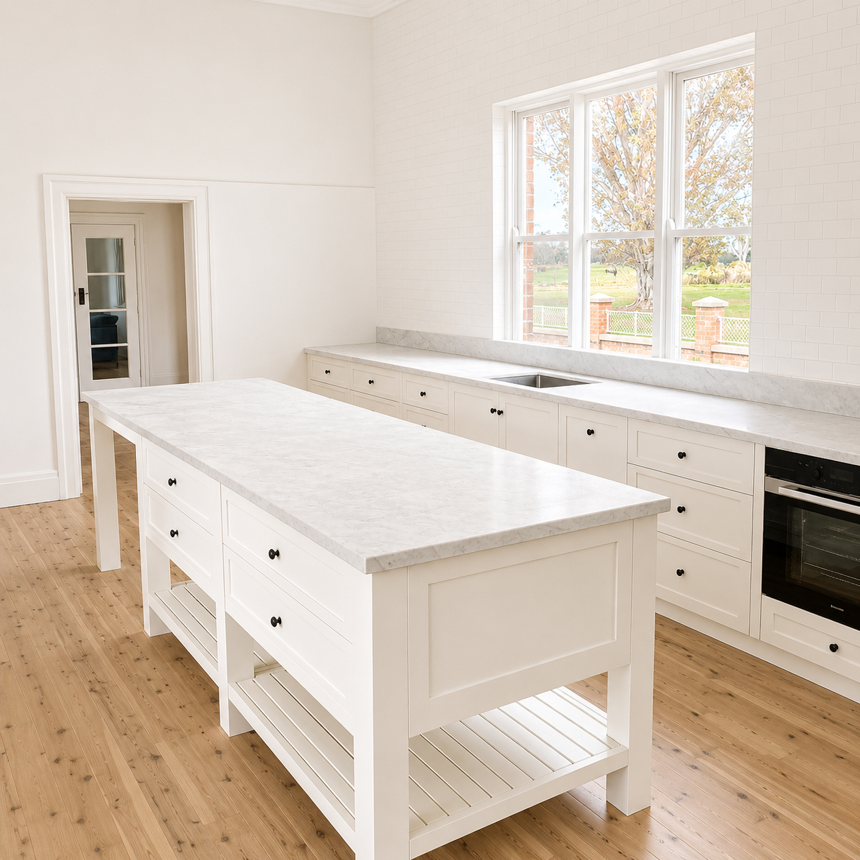 Custom Hamptons-style kitchen with marble island and timber floors at Roachdale