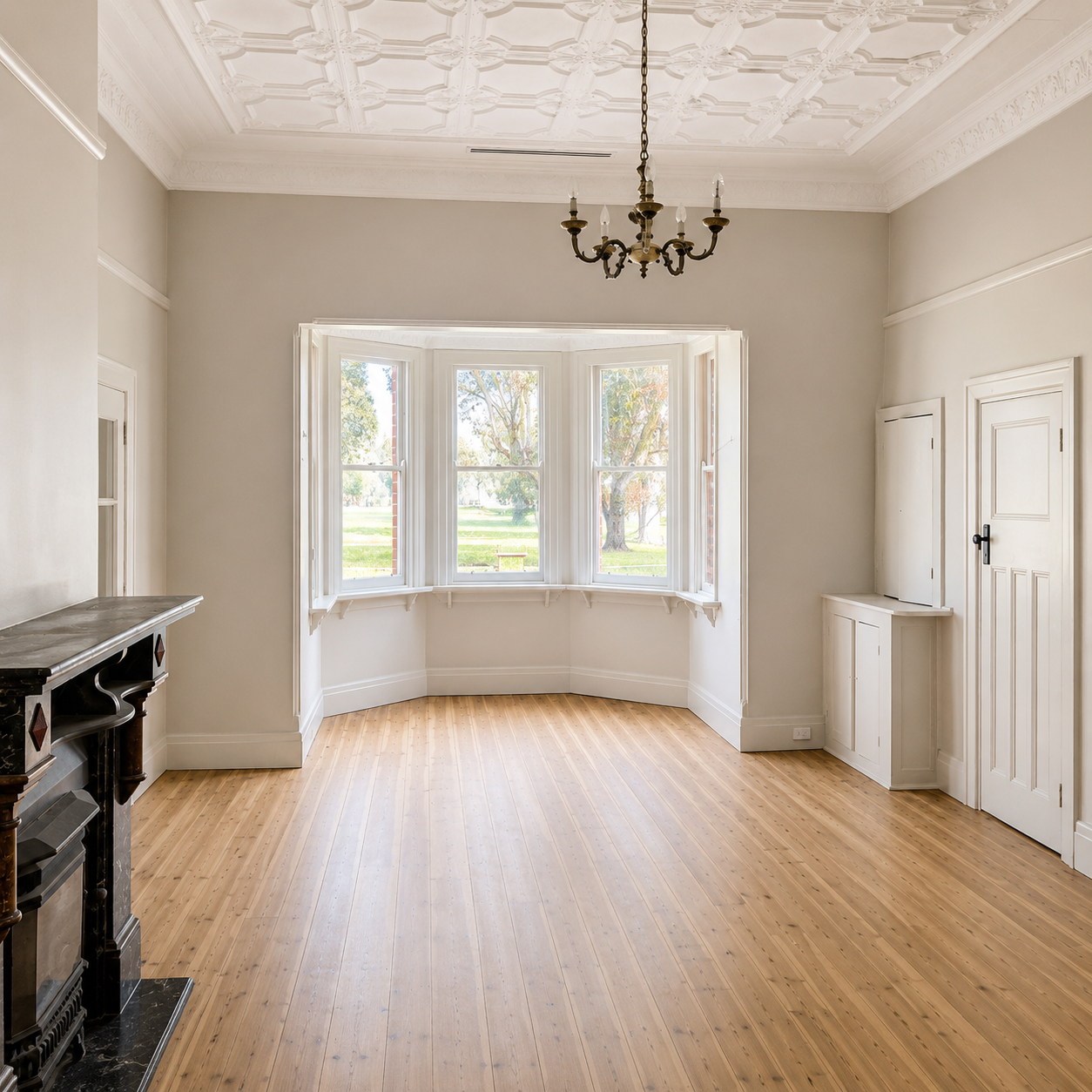 Heritage living room with bay window and polished timber floors at Roachdale