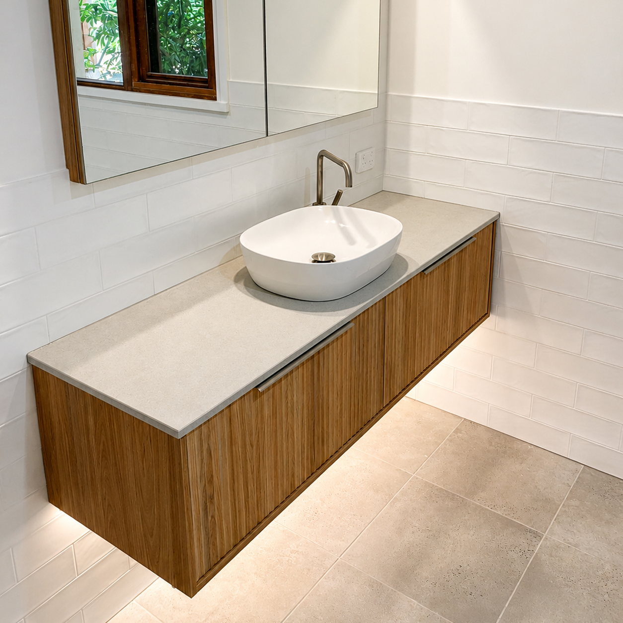 Contemporary bathroom featuring floating timber vanity, vessel basin and mirrored cabinet