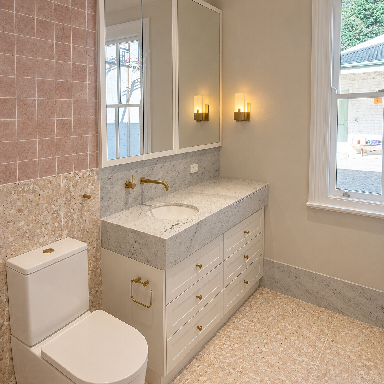 Custom bathroom vanity with stone benchtop and brass tapware in heritage farmhouse renovation