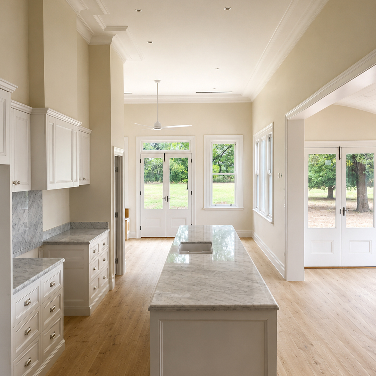 Heritage farmhouse kitchen featuring custom cabinetry and large stone island bench