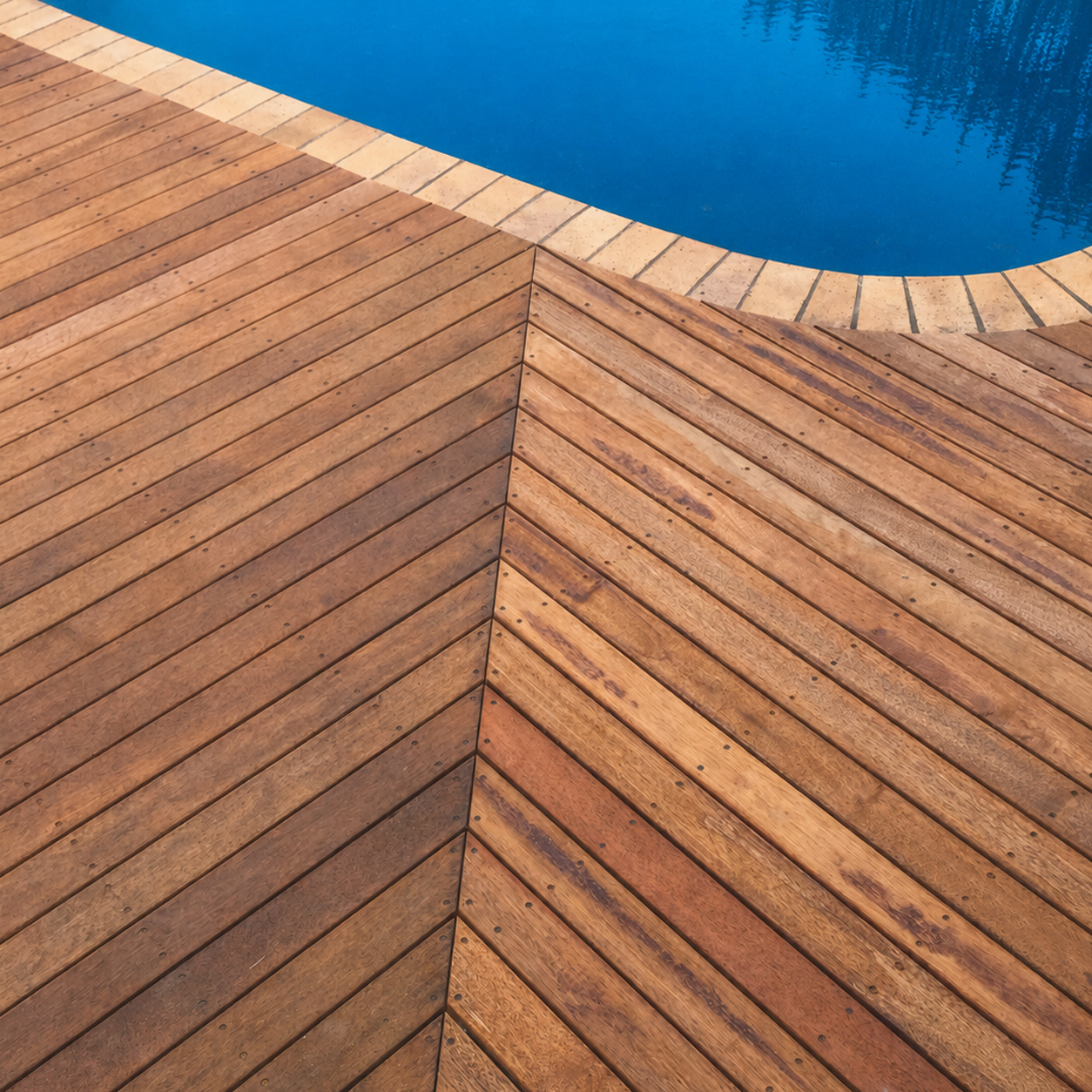 Curved timber pool decking around residential swimming pool